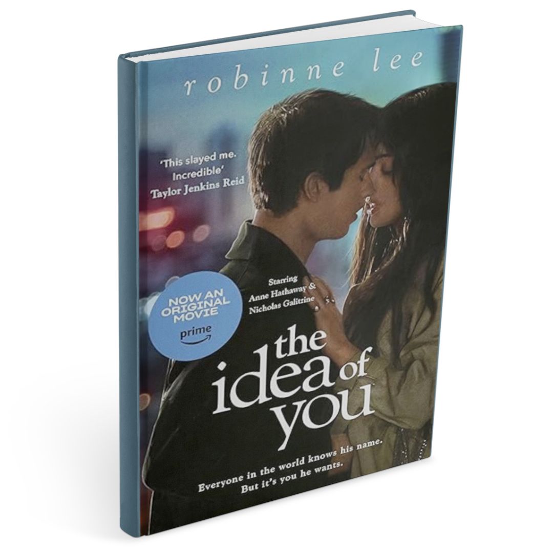 Book cover of The Idea of You by Robinne Lee, an age gap romance trope novel, showing an intimate close-up of an older woman and a younger man about to kiss against a blurred city-night background.