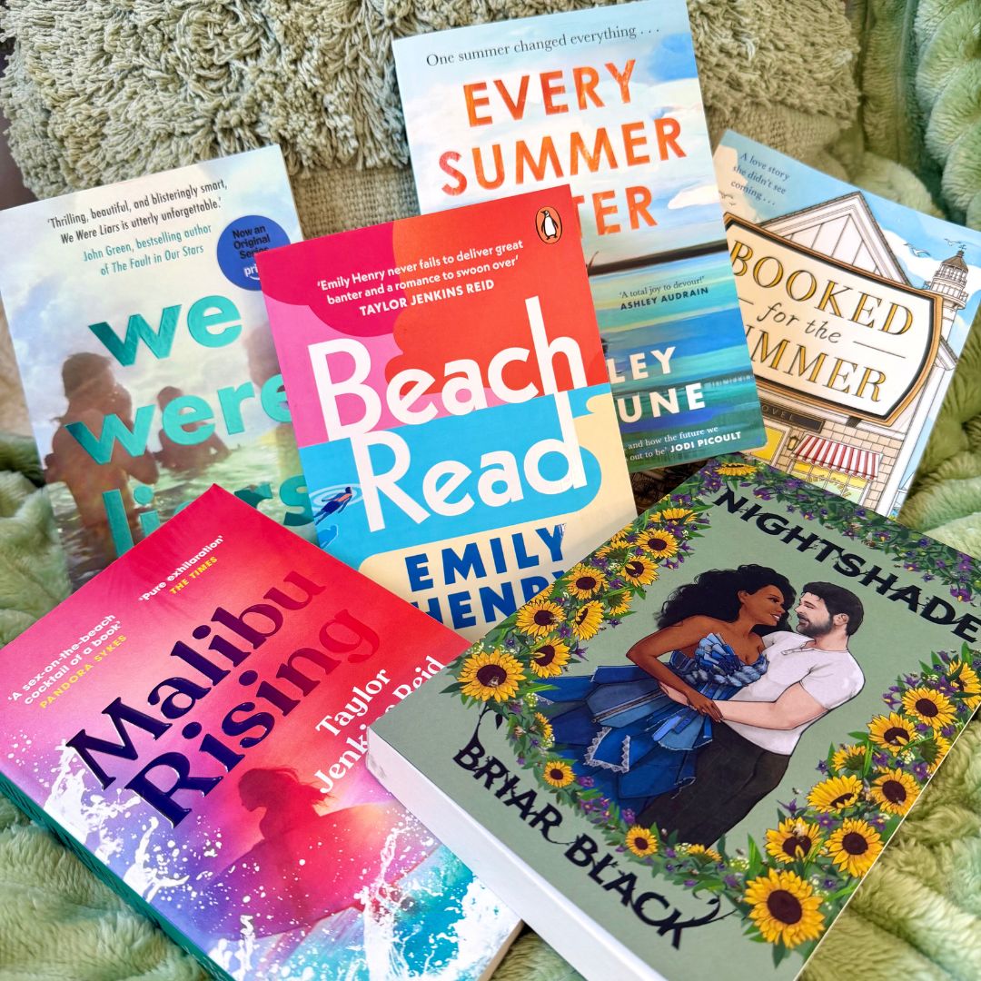 The 6 best summer reads rested against a green tassel pillow and a fluffy green blanket on an egg chair. The books include Every Summer After, We Were Liars, Nightshade, Booked For The Summer, Beach Read, and Malibu Rising.